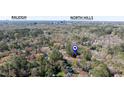 Aerial view showcasing the property's location in Raleigh, surrounded by lush greenery at 5205 Quail Meadows Dr, Raleigh, NC 27609