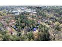 Aerial view of Quail Corners neighborhood with mature trees and surrounding commercial areas at 5205 Quail Meadows Dr, Raleigh, NC 27609