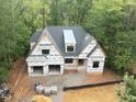 Aerial view of new construction home showcasing the backyard, roofline, and wooded surroundings at 5205 Quail Meadows Dr, Raleigh, NC 27609