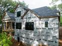Side view of home under construction with large windows and a spacious deck area at 5205 Quail Meadows Dr, Raleigh, NC 27609