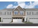 Charming townhome featuring a two-car garage, stone accents, and a shingle-style second story at 6962 Doddridge Ln # 14, Cary, NC 27519