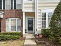 Inviting front entrance with classic black door and landscaped shrubbery at 7628 Winners Edge St, Raleigh, NC 27617