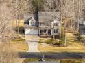 An aerial view of a two-story home with well-maintained landscaping and a long driveway at 765 Carlton St, Clayton, NC 27520