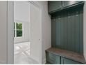 Mud room with built-in bench, storage, and a view to the adjacent living space at 810 Maple Berry Ln # 105, Raleigh, NC 27607
