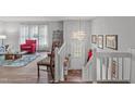Bright entryway featuring hardwood floors, chandelier and view to front door, and living area at 900 Stoneybrook Dr, Sanford, NC 27330