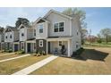 View of the townhome showcasing the exterior and front yard at 918 E Green St # A102, Franklinton, NC 27525