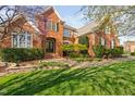 Beautiful brick home featuring a lush green lawn and well-maintained landscaping at 9320 Teton Pines Way, Raleigh, NC 27617