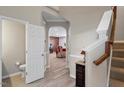 Open foyer featuring hardwood floors, stairs, and an arched doorway leading to the living room at 1008 Garden Square Ln, Morrisville, NC 27560