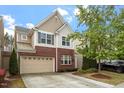 Two-story home with brick and siding, a two-car garage, and well-maintained landscaping at 1008 Garden Square Ln, Morrisville, NC 27560