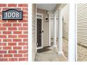 Close-up of front entrance with brick siding and white columns, showcasing the house number at 1008 Garden Square Ln, Morrisville, NC 27560