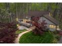 Scenic exterior view showcasing a charming home with a spacious deck and beautifully landscaped yard with a stone pathway at 109 Barcliff Ter, Cary, NC 27518