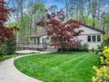 Charming exterior with a lush green lawn, stone pathway, and beautiful landscaping surrounding the house at 109 Barcliff Ter, Cary, NC 27518
