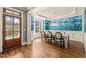 Dining room with hardwood floors, blue floral wallpaper, and a crystal chandelier at 113 Bennett Mountain Trce, Chapel Hill, NC 27516