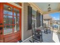 Inviting front porch with rocking chairs and a red front door with glass panels at 113 Bennett Mountain Trce, Chapel Hill, NC 27516