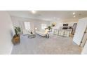 Spacious living room with plush seating, an open floor plan, and ample natural light at 1164 Solace Way, Rolesville, NC 27571