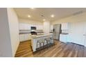 Spacious kitchen with granite countertops, stainless steel appliances, and a kitchen island at 1169 Solace Way, Rolesville, NC 27571