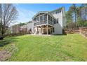 Expansive backyard with a screened porch, patio, and well-maintained lawn at 118 Benedum Pl, Cary, NC 27518