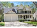 Inviting two-story home with black shutters, white siding, and a well-manicured front lawn at 118 Benedum Pl, Cary, NC 27518