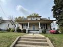 Charming two-story home featuring a covered front porch and traditional architecture at 121 W Young Ave, Henderson, NC 27536