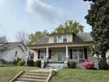 Charming two-story home featuring a covered front porch and traditional architecture at 121 W Young Ave, Henderson, NC 27536