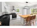 Bright kitchen features stainless steel appliances, black countertops, and a large island with seating at 1306 Ed Cook Rd, Durham, NC 27703