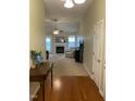 Inviting living room with a fireplace, ceiling fan, and views to a treed backyard at 144 Gremar Dr, Holly Springs, NC 27540
