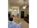 Open living room showcases the entry foyer, ceiling fan, and a comfortable seating area at 144 Gremar Dr, Holly Springs, NC 27540