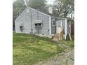 Gray home featuring a white door, fenced yard, and a small porch at 1609 Evergreen St, Durham, NC 27703