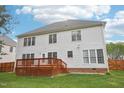 Two story home backyard view, showcasing a wooden deck and a well-maintained lawn at 1903 Yellowwood Ln, Durham, NC 27712