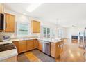 Kitchen with stainless steel appliances, wooden cabinetry, and an adjacent eat-in area and fireplace at 1903 Yellowwood Ln, Durham, NC 27712