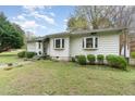 Charming single-story home with large windows, a covered entryway, and mature landscaping in the front yard at 201 E End Ave, Durham, NC 27703