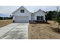 Charming new construction home with a manicured lawn and a freshly paved driveway at 21 Mildred Pl, Broadway, NC 27505