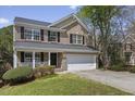 Charming brick home with a well-manicured lawn, black shutters, and attached two car garage at 219 Arbordale Ct, Cary, NC 27518