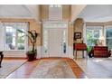 Inviting foyer with hardwood floors, large windows, and elegant decor at 2208 Walden Creek Dr, Apex, NC 27523