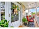 Cozy front porch with chairs, plants, and a decorative wreath on the door at 2208 Walden Creek Dr, Apex, NC 27523