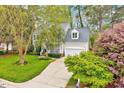 Beautiful two-story home with attached garage and blossoming trees at 2208 Walden Creek Dr, Apex, NC 27523