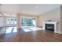 Spacious living room with fireplace, recessed lighting, and sliding doors to the screened deck at 229 Gilliland Rd, Siler City, NC 27344