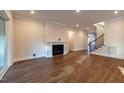 Open living space with modern fireplace, recessed lighting, and hardwood floors at 229 Gilliland Rd, Siler City, NC 27344