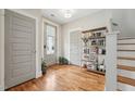 Welcoming foyer features hardwood floors, stylish bookcase, and ample natural light at 233 Airlie Dr, Chapel Hill, NC 27516