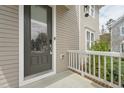 Close up of the front door with brick steps and white railing on a charming home at 233 Airlie Dr, Chapel Hill, NC 27516