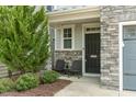 Cozy front porch with chairs, stone pillars, and well-maintained landscaping at 237 Begen St, Morrisville, NC 27560