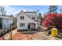 Charming two-story home featuring light-colored siding, black trim windows, and an inviting covered entryway at 2605 Hazelwood Dr, Raleigh, NC 27608