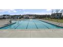 Spacious community pool with multiple lanes for swimming, surrounded by well-maintained concrete at 279 Providence Creek Dr, Fuquay Varina, NC 27526