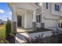 Welcoming front porch with stone columns, providing a cozy entrance to this inviting home at 279 Providence Creek Dr, Fuquay Varina, NC 27526