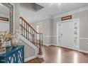 Inviting foyer with hardwood floors, staircase and neutral paint at 2909 Timpani Trl, Apex, NC 27539