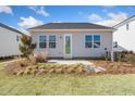 The backyard has a small patio, lawn area, and simple landscaping, perfect for outdoor activities at 293 Providence Creek Dr, Fuquay Varina, NC 27526