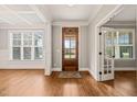 Elegant foyer with hardwood floors and natural light, featuring paneled doors at 2936 Turning Brook Ln, Raleigh, NC 27616