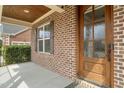 Close-up of the front porch with a wooden door and detailed brickwork at 2936 Turning Brook Ln, Raleigh, NC 27616