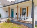 Inviting front porch featuring rocking chairs and a black and white rug, perfect for relaxing at 323 W 5Th St, Burlington, NC 27215