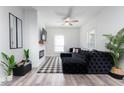 Comfortable living room featuring a fireplace, ceiling fan, and large sectional sofa at 323 W 5Th St, Burlington, NC 27215